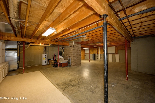 basement featuring heating unit and electric water heater