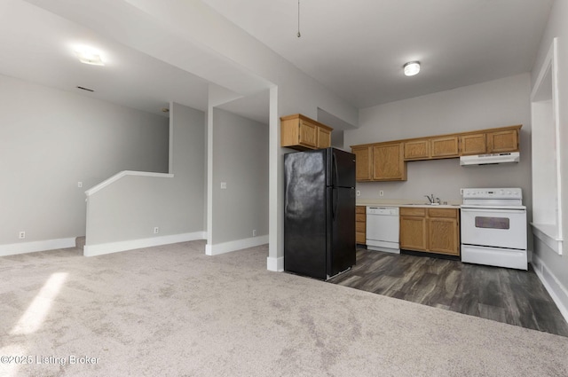 kitchen featuring sink, white appliances, and dark colored carpet