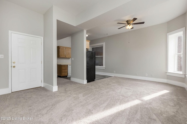 unfurnished living room with light carpet and ceiling fan