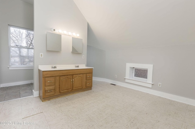 bathroom with vanity and vaulted ceiling