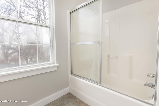 bathroom featuring tile patterned flooring and enclosed tub / shower combo