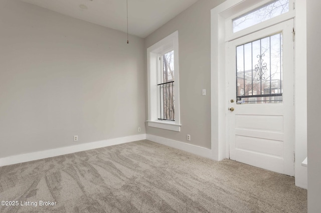 carpeted entryway featuring plenty of natural light