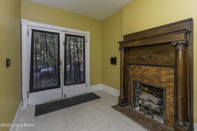 interior space with a tile fireplace