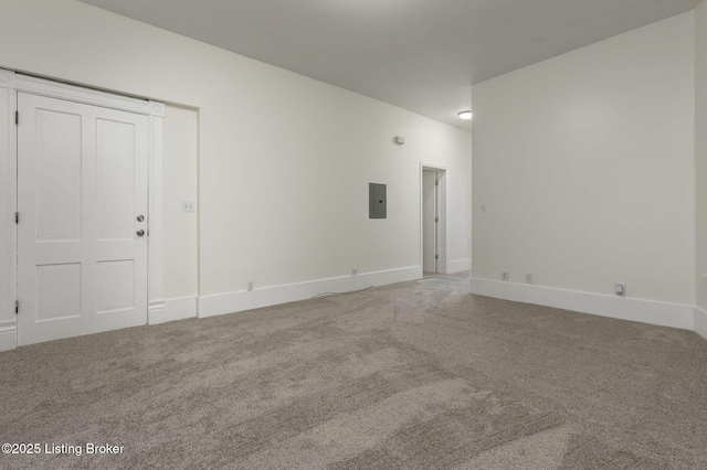 carpeted spare room featuring electric panel