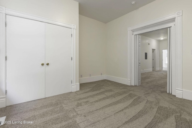 unfurnished bedroom featuring carpet and a closet