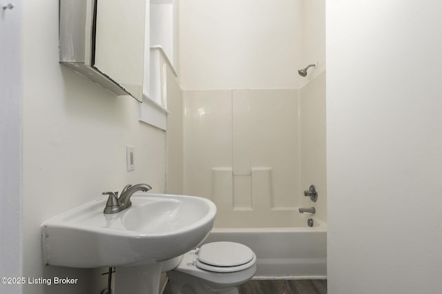 full bathroom with sink, toilet, tub / shower combination, and hardwood / wood-style flooring