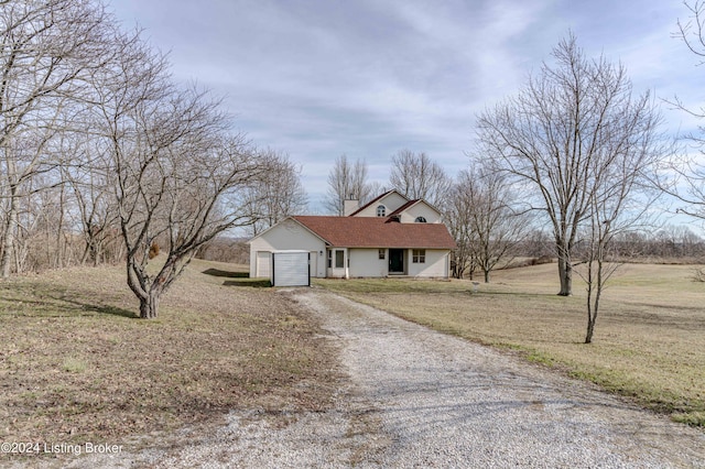 ranch-style house featuring a garage and a front lawn