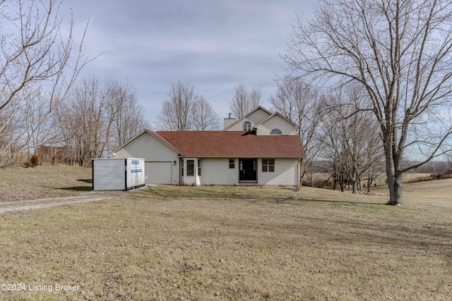 view of front of house with a front lawn and a garage