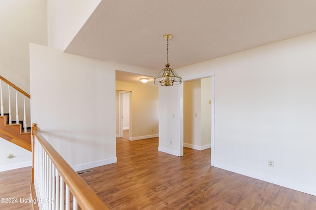 interior space featuring hardwood / wood-style floors and a notable chandelier