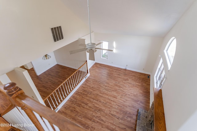 living room featuring wood-type flooring, high vaulted ceiling, and ceiling fan