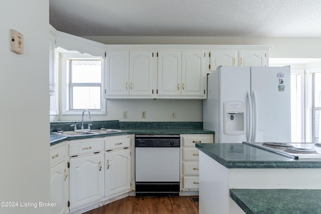 kitchen with a textured ceiling, white cabinetry, white appliances, and sink