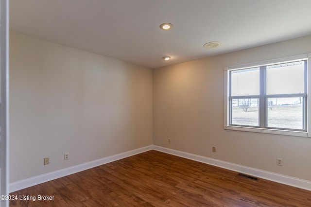 spare room with dark hardwood / wood-style floors