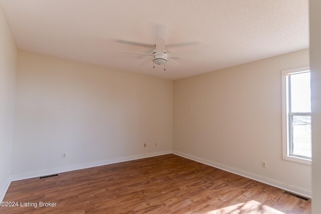 unfurnished room with hardwood / wood-style floors and ceiling fan