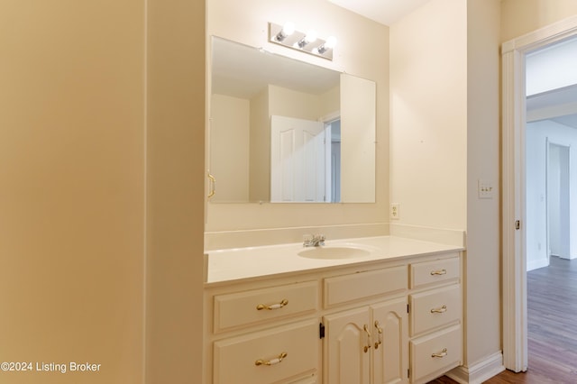 bathroom with vanity and wood-type flooring