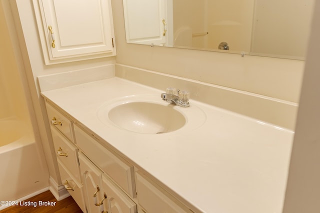 bathroom with hardwood / wood-style floors and vanity