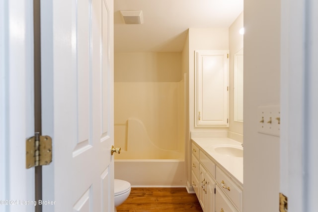 full bathroom with hardwood / wood-style floors, vanity, toilet, and bathing tub / shower combination