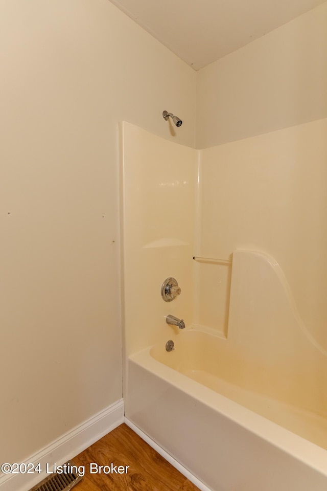 bathroom featuring shower / bathing tub combination and hardwood / wood-style flooring