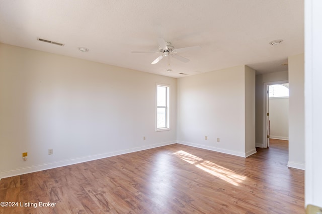 spare room with ceiling fan and hardwood / wood-style flooring