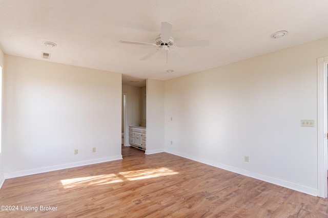 spare room with light wood-type flooring and ceiling fan