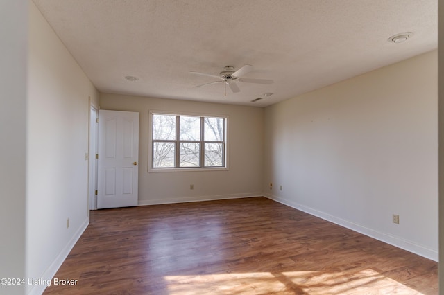 empty room with dark hardwood / wood-style floors and ceiling fan