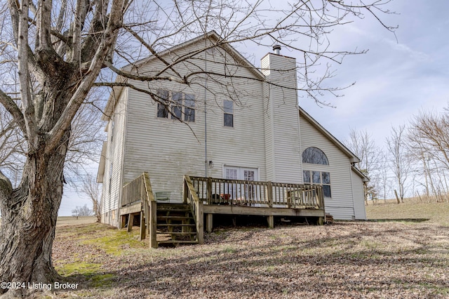 back of house featuring a wooden deck