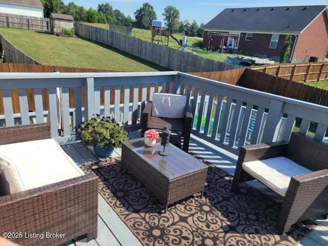 deck featuring an outdoor hangout area and a yard