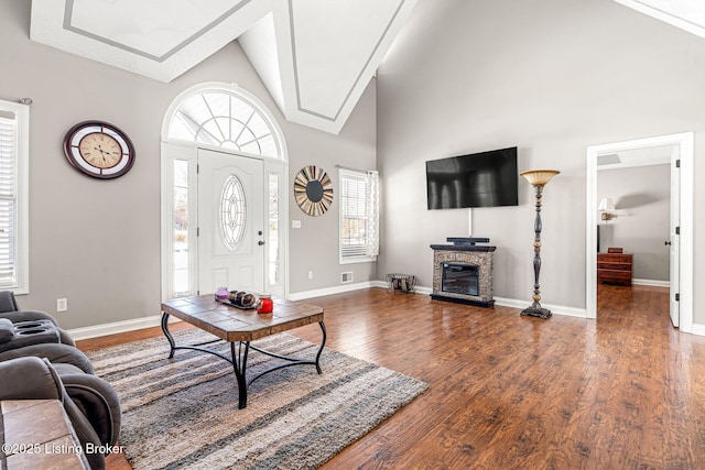 living room featuring high vaulted ceiling and dark wood-type flooring