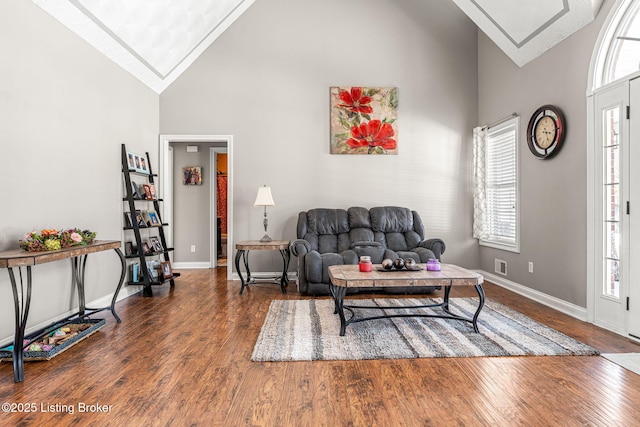 living room featuring ornamental molding, dark hardwood / wood-style floors, and high vaulted ceiling