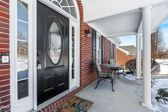 view of snow covered property entrance