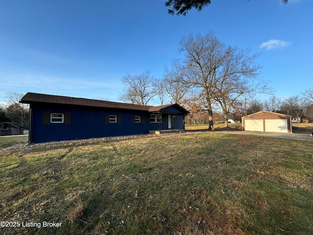 view of front facade featuring an outbuilding, a garage, and a front lawn