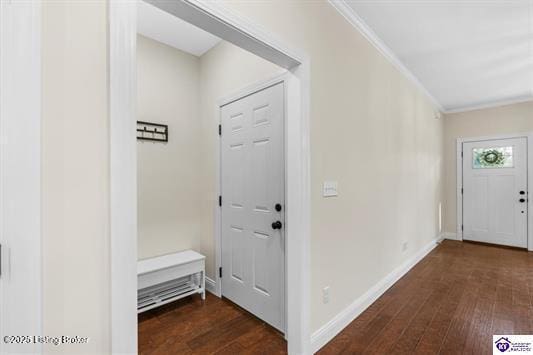 entrance foyer with ornamental molding and dark wood-type flooring