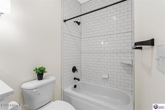 full bathroom with vanity, tiled shower / bath combo, and toilet