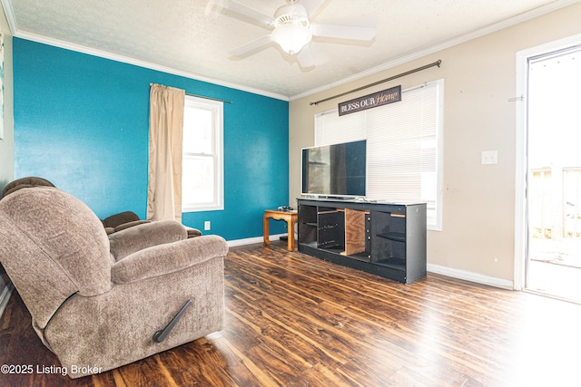 living room featuring hardwood / wood-style flooring, ceiling fan, and crown molding