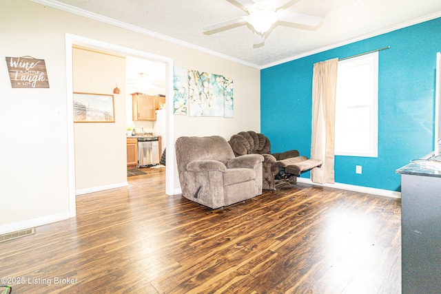 sitting room with ceiling fan, dark hardwood / wood-style flooring, and ornamental molding