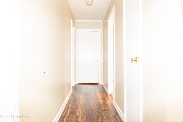 hall with crown molding, dark wood-type flooring, and a textured ceiling