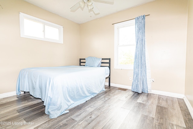 bedroom with hardwood / wood-style flooring and ceiling fan