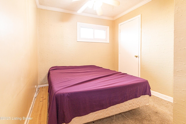 carpeted bedroom with ceiling fan and ornamental molding