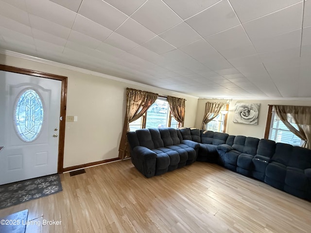 unfurnished living room with wood-type flooring and ornamental molding