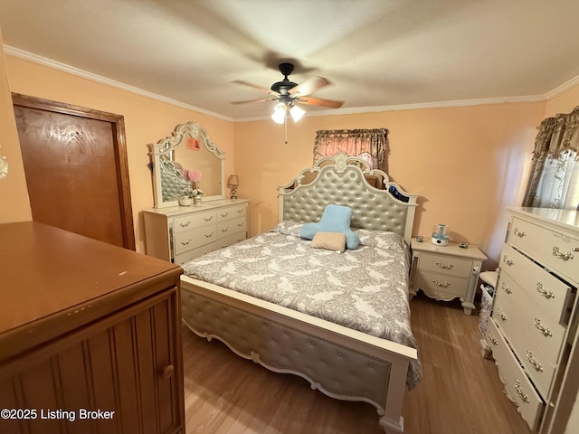 bedroom featuring ceiling fan, dark hardwood / wood-style flooring, and ornamental molding