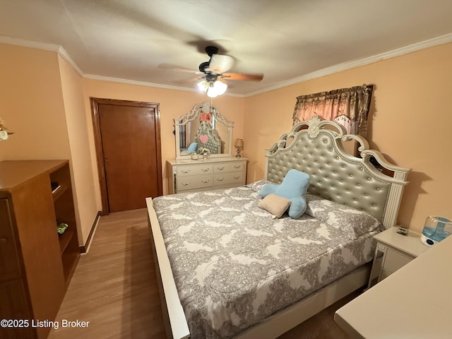 bedroom with ceiling fan, dark hardwood / wood-style flooring, and crown molding