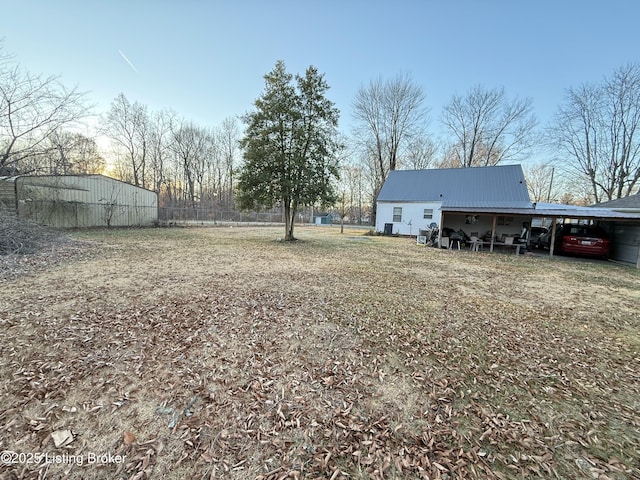 view of yard with an outdoor structure and a carport