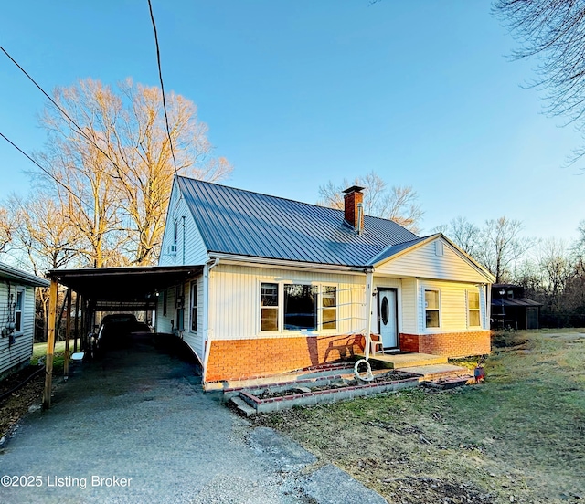 rear view of property with a carport