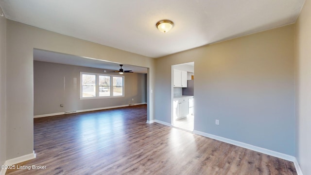 empty room featuring hardwood / wood-style flooring and ceiling fan