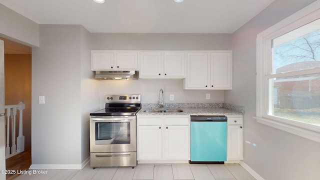 kitchen featuring sink, light stone counters, white cabinetry, and appliances with stainless steel finishes