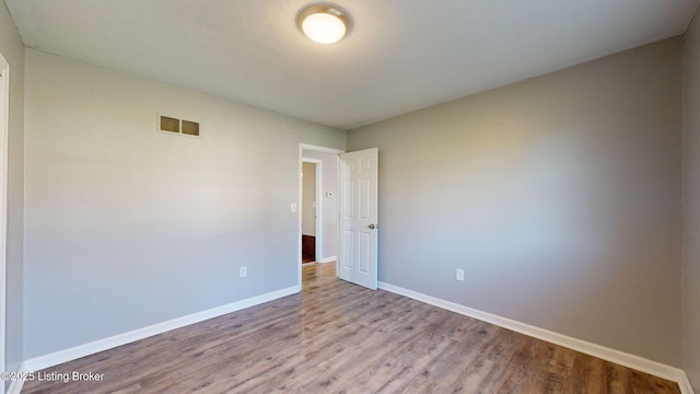 empty room with light hardwood / wood-style flooring