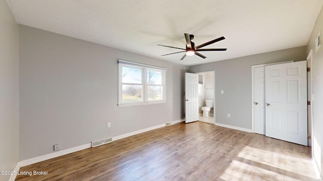 unfurnished bedroom with ceiling fan, light hardwood / wood-style flooring, and ensuite bath