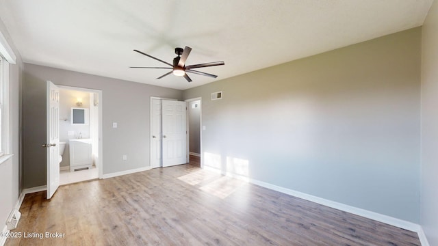 unfurnished bedroom featuring ceiling fan, hardwood / wood-style flooring, and ensuite bathroom