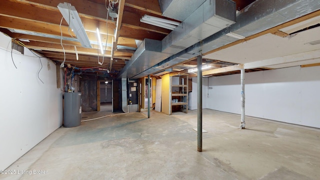 basement featuring heating unit and water heater