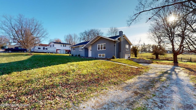 view of home's exterior featuring a garage and a yard