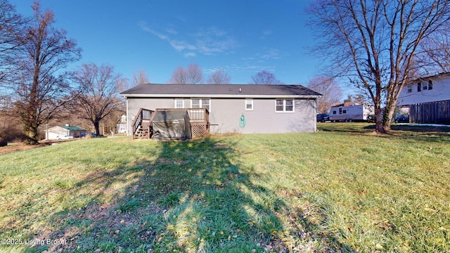 rear view of house featuring a yard